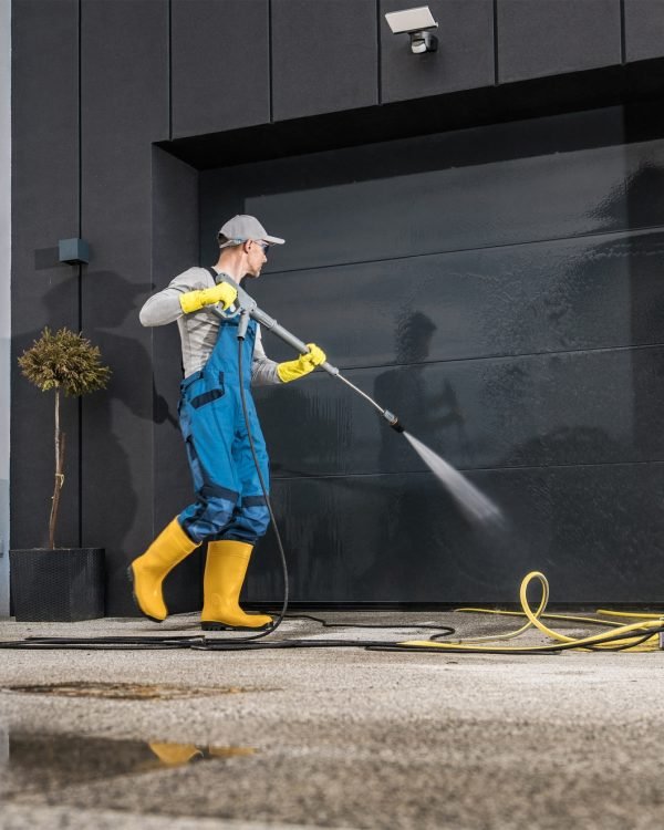 Men Pressure Washing His Garage Gate Men Pressure Washing His Garage Gate
